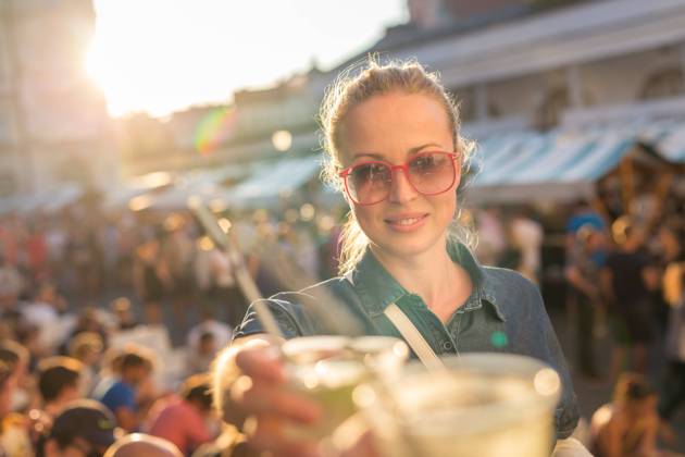 Beautiful young girl toasting on outdoor urban event. Beautiful young girl toasting outdoors on Open kitchen street food festival in Ljubljana, Slovenia. Popular summer urban tourist event in capital., model releasedwoman, toast, drink, festival, event, people, young, music, alcohol, fun, happiness, outdoors, youth, celebration, cheers, group, sunny, together, party, concert, lady, girl, vacations, cheerful, friends, friendship, smiling, summer, culture, food, leisure, adult, outdoor, lifestyle, happy, raised, bonding, cocktail, mohito, beautiful, urban, city, Open kitchen, Odprta kuhna, Ljubljana, Slovenia, square, crowd, tourism, tourist,