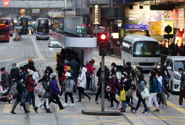 (210101) -- HONG KONG, Jan. 1, 2021 -- People wearing face masks walk on a street in Hong Kong, south China, Jan. 1, 2021. Hong Kong s Center for Health Protection (CHP) reported 42 additional confirmed cases of COVID-19 on Friday, which was a new low since mid-November. The new cases included 36 local infections, with 13 cases of unknown origin. The tally was taken to 8,888. ) CHINA-HONG KONG-COVID-19-CASES (CN) LixGang