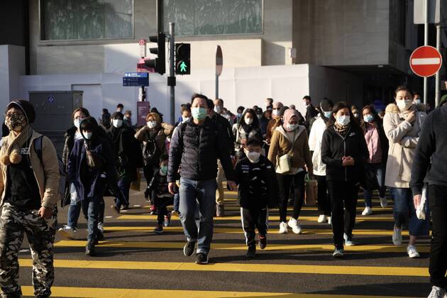 (210101) -- HONG KONG, Jan. 1, 2021 -- People wearing face masks walk on a street in Hong Kong, south China, Jan. 1, 2021. Hong Kong s Center for Health Protection (CHP) reported 42 additional confirmed cases of COVID-19 on Friday, which was a new low since mid-November. The new cases included 36 local infections, with 13 cases of unknown origin. The tally was taken to 8,888. ) CHINA-HONG KONG-COVID-19-CASES (CN) WangxShen