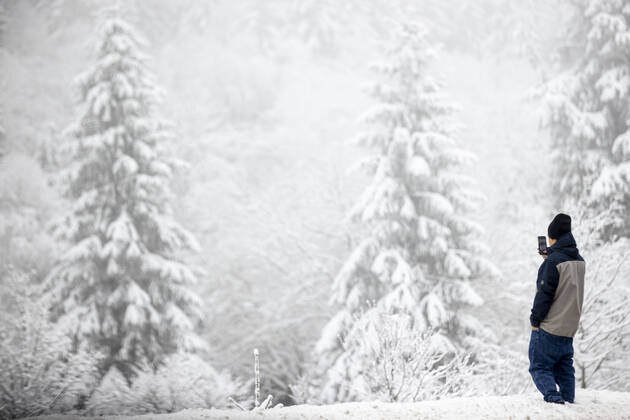 08.01.2021 , WINTERBERG , SAUERLAND , Winter , Schnee , Winterberg bereitet sich auf den nächsten Ansturm der Menschen am Wochenende vor. Ein Jugendlicher steht am Waldrand und macht ein Foto mit seinem Smartphone.