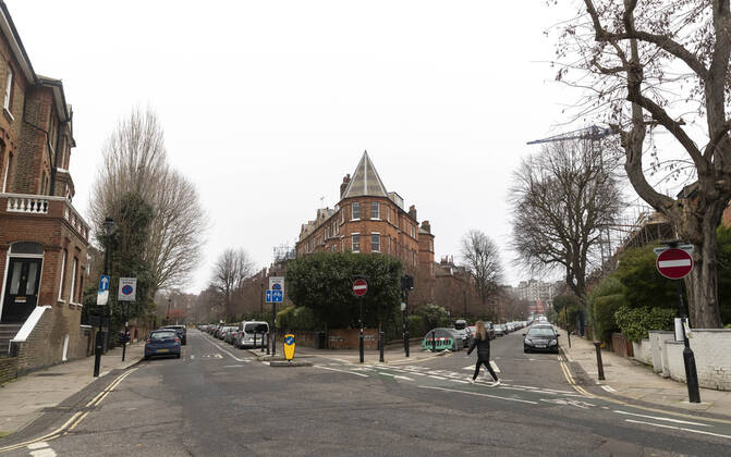 (210110) -- LONDON, Jan. 10, 2021 -- A woman walks in a quiet residential area in London, Britain, Jan. 10, 2021. The coronavirus-related deaths in Britain surpassed 80,000 on Saturday with another 1,035 reported in the country. ) BRITAIN-LONDON-COVID-19-CASES HanxYan 