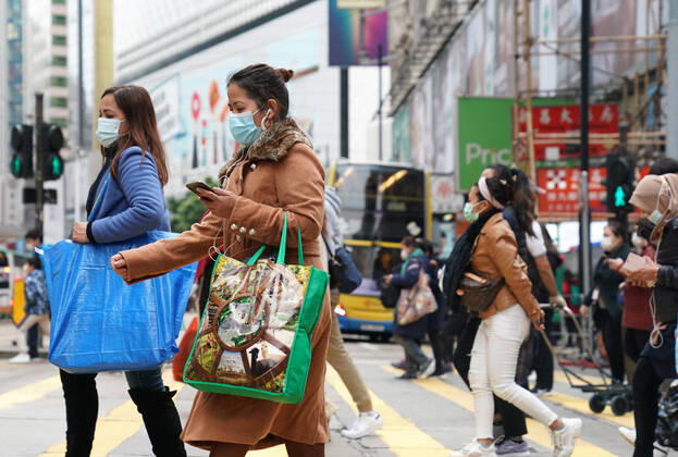 (210110) -- HONG KONG, Jan. 10, 2021 -- People wearing face masks walk on a street in south China s Hong Kong, Jan. 10, 2021. Hong Kong s Center for Health Protection (CHP) reported 31 additional confirmed cases of COVID-19 on Sunday, taking its total tally to 9,242. ) CHINA-HONG KONG-COVID-19-CASES LixGang 