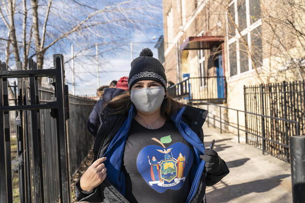 First day of mass vaccination in NYC Teacher Noelle Gold teacher of public school PS 14 waits in line to get COVID-19 vaccine at South Bronx Educational Campus. She proubly displayed her NYS t-shirt. People over 75, education workers, the police and firefighters, public transit and safety workers are eligible to get vaccine as group 1B. Group 1A includes healthcare workers. More than 600 people registered to get vaccinated on this location on the first day. New York New York United States Copyright: LevxRadin