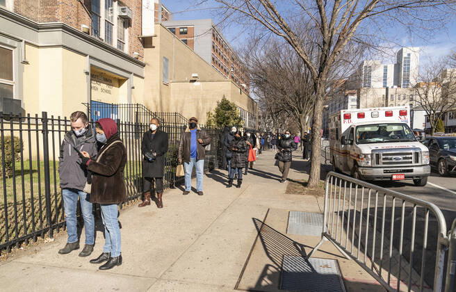 First day of mass vaccination in NYC People who are eligible and registered wait in line to get COVID-19 vaccine at South Bronx Educational Campus. People over 75, education workers, the police and firefighters, public transit and safety workers are eligible to get vaccine as group 1B. Group 1A includes healthcare workers. More than 600 people registered to get vaccinated on this location on the first day. New York New York United States Copyright: LevxRadin