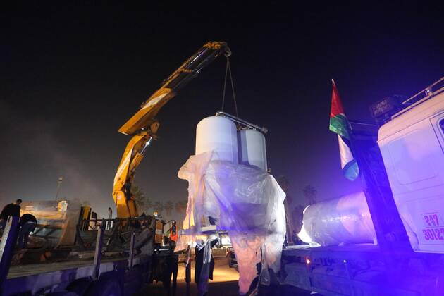 January 10, 2021, Rafah, Gaza Strip, Palestinian Territory: Palestinians receive medical aid from the United Arab Emirate, in Rafah border crossing in the southern of Gaza Strip, on January 10, 2021. The second shipment of Emirati medical aid arrived in the Gaza Strip this evening, which includes medical aid provided to the Ministry of Health in the Gaza Strip, to enhance health efforts in the face of the Corona pandemic, including an oxygen production plant with all its accessories, respirators and other medical equipment Rafah Palestinian Territory - ZUMAap3_ 20210110_zaf_ap3_098 Copyright: xAshrafxAmrax