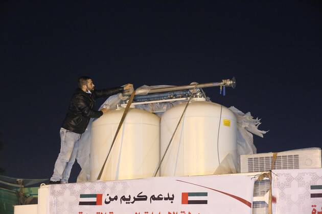 January 10, 2021, Rafah, Gaza Strip, Palestinian Territory: Palestinians receive medical aid from the United Arab Emirate, in Rafah border crossing in the southern of Gaza Strip, on January 10, 2021. The second shipment of Emirati medical aid arrived in the Gaza Strip this evening, which includes medical aid provided to the Ministry of Health in the Gaza Strip, to enhance health efforts in the face of the Corona pandemic, including an oxygen production plant with all its accessories, respirators and other medical equipment Rafah Palestinian Territory - ZUMAap3_ 20210110_zaf_ap3_102 Copyright: xAshrafxAmrax