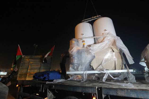 January 10, 2021, Rafah, Gaza Strip, Palestinian Territory: Palestinians receive medical aid from the United Arab Emirate, in Rafah border crossing in the southern of Gaza Strip, on January 10, 2021. The second shipment of Emirati medical aid arrived in the Gaza Strip this evening, which includes medical aid provided to the Ministry of Health in the Gaza Strip, to enhance health efforts in the face of the Corona pandemic, including an oxygen production plant with all its accessories, respirators and other medical equipment Rafah Palestinian Territory - ZUMAap3_ 20210110_zaf_ap3_107 Copyright: xAshrafxAmrax