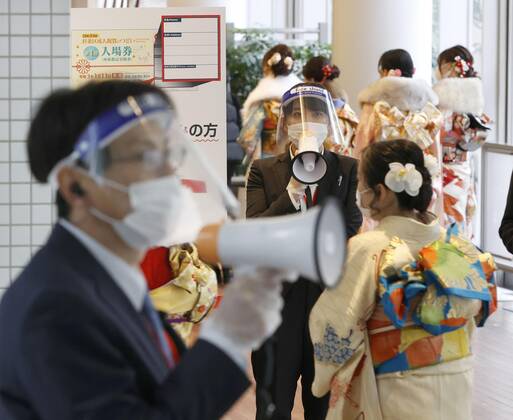 Coming-of-age ceremony under virus state of emergency Women clad in kimono enter the venue of a coming-of-age ceremony in Tokyo s Suginami Ward on Jan. 11, 2021, wearing face masks as the capital is under a coronavirus state of emergency. 
