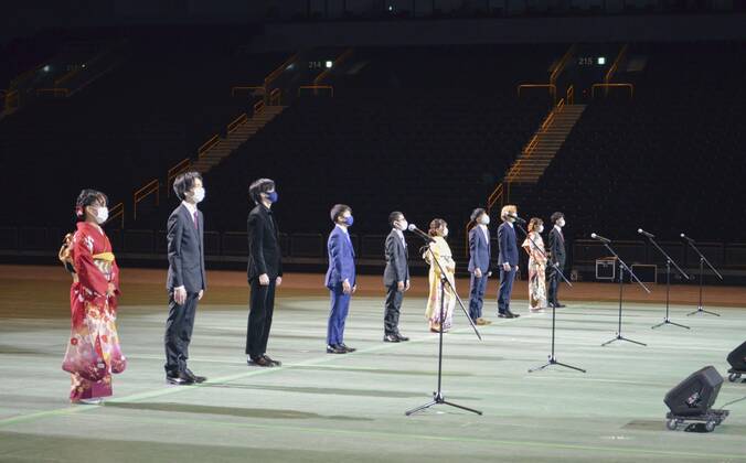 Coming-of-Age ceremony under virus state of emergency Photo taken on Jan. 11, 2021, shows 10 people attending a coming-of-age ceremony at Saitama Super Arena near Tokyo, broadcast online for other people in the city who would have attended it without the coronavirus pandemic. The 10 people organized the ceremony, held at a time when the Tokyo metropolitan area is under a virus state of emergency.