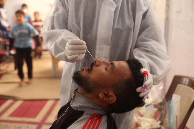 (210111) -- RAFAH, Jan. 11, 2021 -- A medical worker collects a swab sample from a man to test for the COVID-19 in the southern Gaza Strip city of Rafah, Jan. 11, 2021. (Photo by Xinhua) MIDEAST-GAZA-RAFAH-COVID-19-TEST KhaledxOmar 