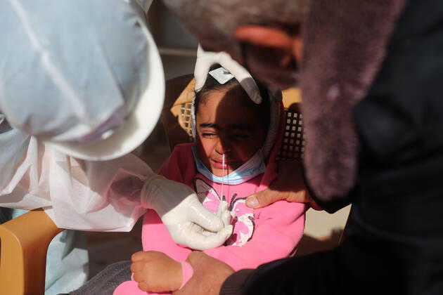 (210111) -- RAFAH, Jan. 11, 2021 -- A medical worker collects a swab sample from a girl to test for the COVID-19 in the southern Gaza Strip city of Rafah, Jan. 11, 2021. (Photo by Xinhua) MIDEAST-GAZA-RAFAH-COVID-19-TEST KhaledxOmar 