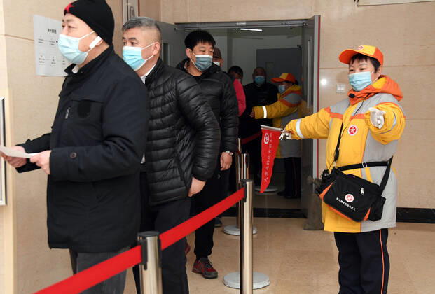 (210111) -- BEIJING, Jan. 11, 2021 -- A member of staff guides recipients for orderly inoculation with COVID-19 vaccines at a temporary inoculation site in Haidian District in Beijing, capital of China, Jan. 11, 2021. Over 1 million people in Beijing had received the first dose of COVID-19 vaccine as of 11 a.m. Monday, the municipal health commission said. TO GO WITH Over 1 mln get COVID-19 vaccine in Beijing ) CHINA-BEIJING-COVID-19 VACCINE-1 MILLION-INOCULATIONS (CN) RenxChao 