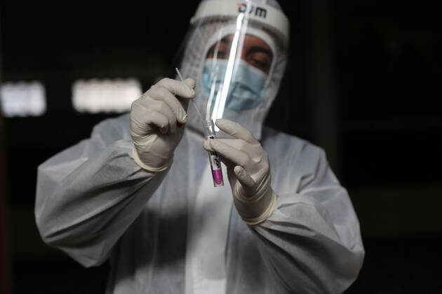 January 11, 2021, Deir Al-Balah, Gaza Strip, Palestinian Territory: A Palestinian medical worker wearing protective gear, takes a random swab sample for COVID-19 testing inside a mosque, in Deir al-Balah, central of Gaza Strip, on January 11, 2021. The Palestinian Authority (PA) has said it expects to receive its first COVID-19 vaccine doses in March under a deal with British drug giant AstraZeneca, and accused Israel of ignoring its responsibilities to ensure vaccines are available in occupied territory Deir Al-Balah Palestinian Territory - ZUMAap3_ 20210111_zaf_ap3_046 Copyright: xAshrafxAmrax