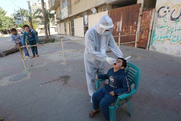 January 11, 2021, Deir Al-Balah, Gaza Strip, Palestinian Territory: A Palestinian medical worker wearing protective gear, takes a random swab sample for COVID-19 testing, in Deir al-Balah, central of Gaza Strip, on January 11, 2021. The Palestinian Authority (PA) has said it expects to receive its first COVID-19 vaccine doses in March under a deal with British drug giant AstraZeneca, and accused Israel of ignoring its responsibilities to ensure vaccines are available in occupied territory Deir Al-Balah Palestinian Territory - ZUMAap3_ 20210111_zaf_ap3_069 Copyright: xAshrafxAmrax