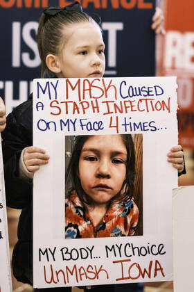 January 11, 2021, Des Moines, Iowa, U.S: A child holds up a sign in the Rotunda of the Iowa State Capitol in Des Moines. Hundreds of Iowans from across the state came to the State Capitol to protest the Governor s COVID-19 mitigation efforts. The Coronavirus (SARS-CoV-2) mitigation guidelines include a mask mandate indoors when it isn t possible to social distance. But the Governor specifically exempted the State Capitol. No one in the crowd wore a mask and there was no effort to follow social distancing guidelines. There were also anti-Vaxxers in the crowd who protested the vaccine efforts and said vaccines were unsafe. Des Moines U.S. - ZUMAk94_ 20210111_zaf_k94_006 Copyright: xJackxKurtzx