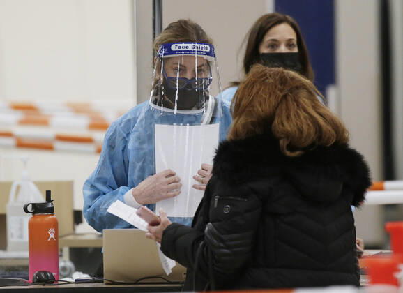 People arrive and get checked in to receive a coronavirus vaccine at an Essex County COVID-19 Vaccination Site located at a closed Sears retail store in the Livingston Mall in Livingston, New Jersey on Monday, January 11, 2021. Public health agencies and health-care groups are using the retailer s empty stores to deliver Vaccines in several locations around parts of the United States.  NYP20210111107 JohnxAngelillo