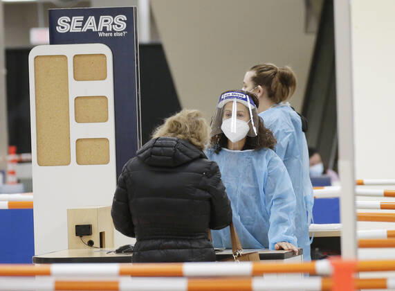 People arrive and get checked in to receive a coronavirus vaccine at an Essex County COVID-19 Vaccination Site located at a closed Sears retail store in the Livingston Mall in Livingston, New Jersey on Monday, January 11, 2021. Public health agencies and health-care groups are using the retailer s empty stores to deliver Vaccines in several locations around parts of the United States.  NYP20210111108 JohnxAngelillo