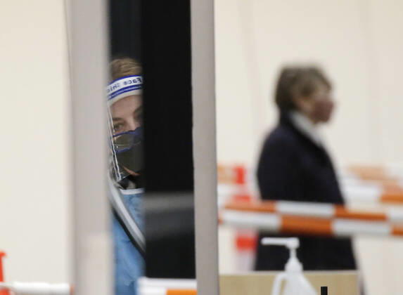 People arrive and get checked in to receive a coronavirus vaccine at an Essex County COVID-19 Vaccination Site located at a closed Sears retail store in the Livingston Mall in Livingston, New Jersey on Monday, January 11, 2021. Public health agencies and health-care groups are using the retailer s empty stores to deliver Vaccines in several locations around parts of the United States.  NYP20210111109 JohnxAngelillo