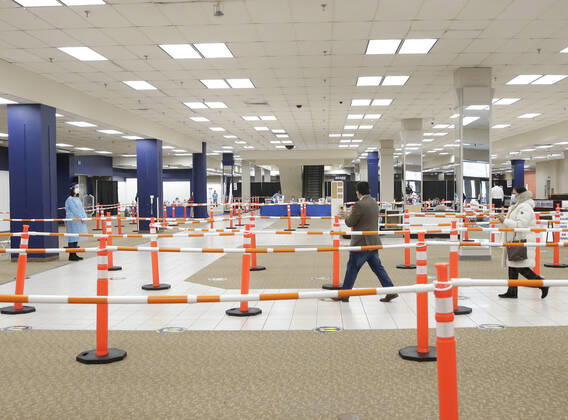 People arrive and get checked in to receive a coronavirus vaccine at an Essex County COVID-19 Vaccination Site located at a closed Sears retail store in the Livingston Mall in Livingston, New Jersey on Monday, January 11, 2021. Public health agencies and health-care groups are using the retailer s empty stores to deliver Vaccines in several locations around parts of the United States.  NYP20210111110 JohnxAngelillo