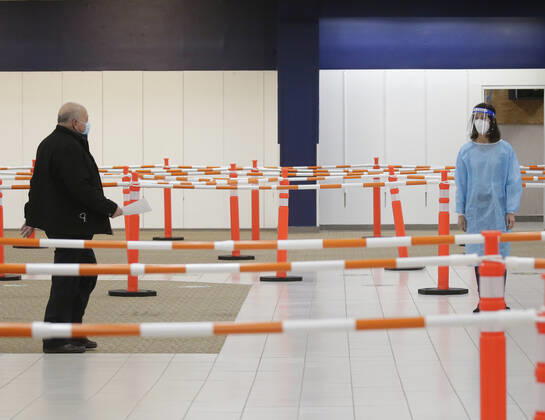 People arrive and get checked in to receive a coronavirus vaccine at an Essex County COVID-19 Vaccination Site located at a closed Sears retail store in the Livingston Mall in Livingston, New Jersey on Monday, January 11, 2021. Public health agencies and health-care groups are using the retailer s empty stores to deliver Vaccines in several locations around parts of the United States.  NYP20210111111 JohnxAngelillo