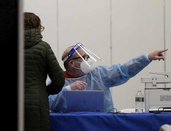 People arrive and get checked in to receive a coronavirus vaccine at an Essex County COVID-19 Vaccination Site located at a closed Sears retail store in the Livingston Mall in Livingston, New Jersey on Monday, January 11, 2021. Public health agencies and health-care groups are using the retailer s empty stores to deliver Vaccines in several locations around parts of the United States.  NYP20210111112 JohnxAngelillo