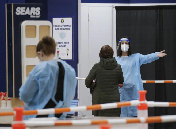 People arrive and get checked in to receive a coronavirus vaccine at an Essex County COVID-19 Vaccination Site located at a closed Sears retail store in the Livingston Mall in Livingston, New Jersey on Monday, January 11, 2021. Public health agencies and health-care groups are using the retailer s empty stores to deliver Vaccines in several locations around parts of the United States.  NYP20210111113 JohnxAngelillo