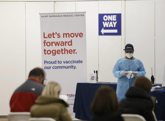 People arrive and get checked in to receive a coronavirus vaccine at an Essex County COVID-19 Vaccination Site located at a closed Sears retail store in the Livingston Mall in Livingston, New Jersey on Monday, January 11, 2021. Public health agencies and health-care groups are using the retailer s empty stores to deliver Vaccines in several locations around parts of the United States.  NYP20210111114 JohnxAngelillo
