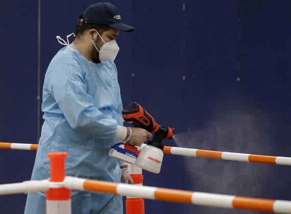 Workers sanitize areas where people enter to receive a coronavirus vaccine at an Essex County COVID-19 Vaccination Site located at a closed Sears retail store in the Livingston Mall in Livingston, New Jersey on Monday, January 11, 2021. Public health agencies and health-care groups are using the retailer s empty stores to deliver Vaccines in several locations around parts of the United States.  NYP20210111115 JohnxAngelillo