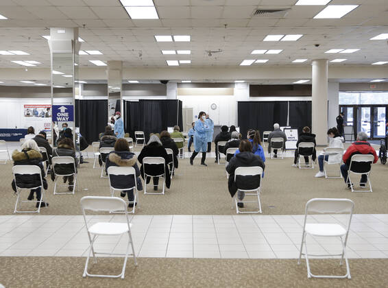 People arrive and get checked in to receive a coronavirus vaccine at an Essex County COVID-19 Vaccination Site located at a closed Sears retail store in the Livingston Mall in Livingston, New Jersey on Monday, January 11, 2021. Public health agencies and health-care groups are using the retailer s empty stores to deliver Vaccines in several locations around parts of the United States.  NYP20210111117 JohnxAngelillo