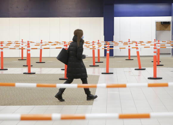 People arrive and get checked in to receive a coronavirus vaccine at an Essex County COVID-19 Vaccination Site located at a closed Sears retail store in the Livingston Mall in Livingston, New Jersey on Monday, January 11, 2021. Public health agencies and health-care groups are using the retailer s empty stores to deliver Vaccines in several locations around parts of the United States.  NYP20210111118 JohnxAngelillo
