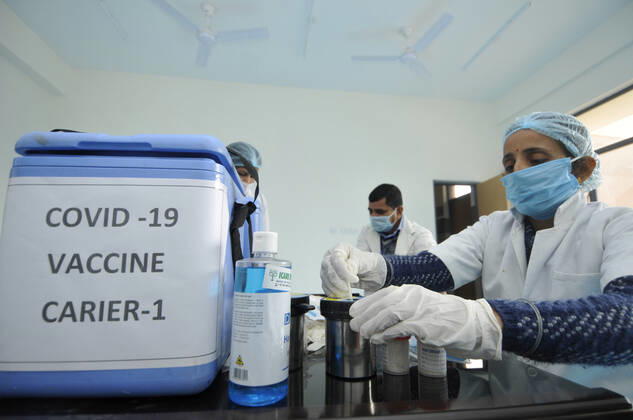 NOIDA, INDIA - JANUARY 11: A health worker seen next to a vaccine carrier during a dry-run of Covid-19 vaccine at Bhangel CHC hospital, on January 11, 2021 in Noida, India. Prime Minister Narendra Modi on Monday spoke on India s vaccination plan ahead of the mega Covid-19 vaccination drive, which is set to start on 16 January, 2021. Around 3 crore healthcare workers and frontline workers will be vaccinated in the first phase of vaccination. In the 2nd phase, those above 50 years and those under 50 years with co-morbid conditions will be vaccinated, the Prime Minister said. (Photo by Sunil Ghosh Hindustan Times) Covid-19 Vaccine Dry Run