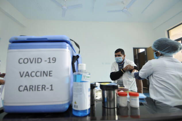 NOIDA, INDIA - JANUARY 11: A health worker seen next to a vaccine carrier during a dry-run of Covid-19 vaccine at Bhangel CHC hospital, on January 11, 2021 in Noida, India. Prime Minister Narendra Modi on Monday spoke on India s vaccination plan ahead of the mega Covid-19 vaccination drive, which is set to start on 16 January, 2021. Around 3 crore healthcare workers and frontline workers will be vaccinated in the first phase of vaccination. In the 2nd phase, those above 50 years and those under 50 years with co-morbid conditions will be vaccinated, the Prime Minister said. (Photo by Sunil Ghosh Hindustan Times) Covid-19 Vaccine Dry Run