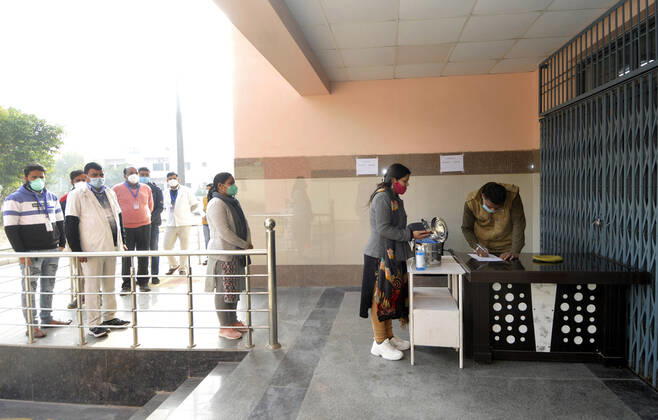 NOIDA, INDIA - JANUARY 11: Volunteers queue during a dry-run of Covid-19 vaccine at Bhangel CHC hospital, on January 11, 2021 in Noida, India. Prime Minister Narendra Modi on Monday spoke on India s vaccination plan ahead of the mega Covid-19 vaccination drive, which is set to start on 16 January, 2021. Around 3 crore healthcare workers and frontline workers will be vaccinated in the first phase of vaccination. In the 2nd phase, those above 50 years and those under 50 years with co-morbid conditions will be vaccinated, the Prime Minister said. (Photo by Sunil Ghosh Hindustan Times) Covid-19 Vaccine Dry Run