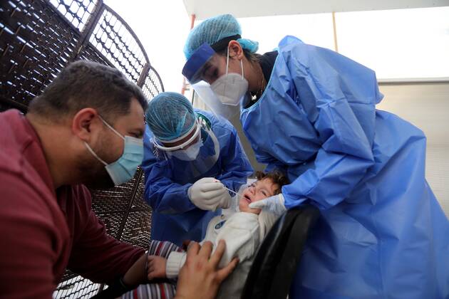 (210111) -- BEIRUT, Jan. 11, 2021 -- A health worker collects a COVID-19 PCR swab from a child at a hospital in Beirut, Lebanon, on Jan. 11, 2021. Lebanon s Higher Defense Council declared on Monday a state of emergency between Jan. 14-25 that includes a total lockdown in hope to restrict further spread of COVID-19, Al-Jadeed local TV channel reported. ) LEBANON-BEIRUT-COVID-19-STATE OF EMERGENCY BilalxJawich 
