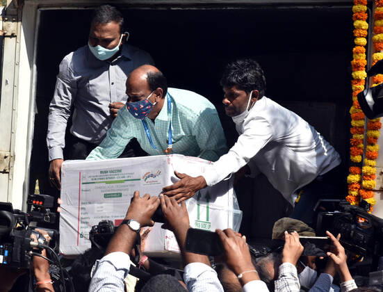 (210112) -- HYDERABAD, Jan. 12, 2021 -- Health workers carry a box containing COVID-19 vaccine from a refrigerated vehicle to a cold storage in Hyderabad, capital of India s southern state of Telengana, Jan. 12, 2021. India s federal government said that the COVID-19 vaccination drive will begin in the country on Jan. 16. The roll-out of COVID-19 vaccine will provide priority to the healthcare workers and the frontline workers who are estimated to be around 30 million. (Photo by Xinhua) INDIA-HYDERABAD-COVID-19-VACCINE ParthaxSarkar 