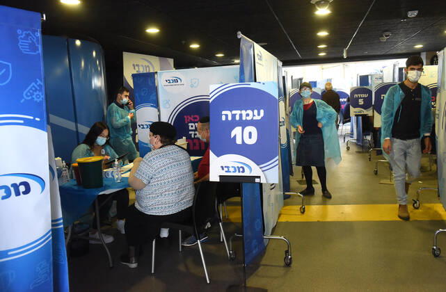 People receive their second shot of the Pfizer- BioNTech COVID-19 vaccine in an Israeli vaccination center in Jerusalem, on Tuesday, January 12, 2021. Israel will expand the vaccination drive inoculating teachers and people over 50 years on Wednesday.  JER2021011211 DEBBIExHILL
