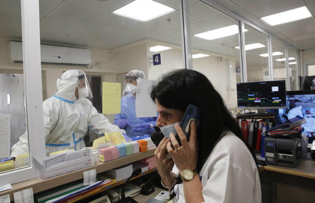 (210112) -- ASHKELON (ISRAEL), Jan. 12, 2021 -- Israeli medical staff wearing protective gear work in a COVID-19 isolation ward at Barzilai Medical Center in Ashkelon, southern Israel, on Jan. 12, 2021. Israel s Ministry of Health reported 9,242 new COVID-19 cases on Tuesday, bringing the total number in the country to 508,604. (Photo by Xinhua) ISRAEL-ASHKELON-COVID-19-CASES GilxCohenxMagen 