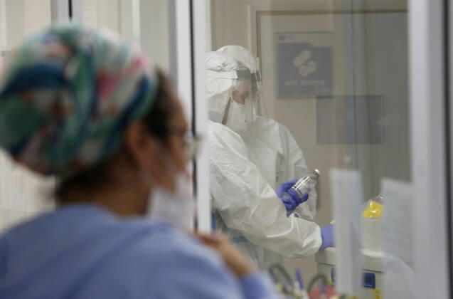 (210112) -- ASHKELON (ISRAEL), Jan. 12, 2021 -- Israeli medical staff wearing protective gear work in a COVID-19 isolation ward at Barzilai Medical Center in Ashkelon, southern Israel, on Jan. 12, 2021. Israel s Ministry of Health reported 9,242 new COVID-19 cases on Tuesday, bringing the total number in the country to 508,604. (Photo by Xinhua) ISRAEL-ASHKELON-COVID-19-CASES GilxCohenxMagen 