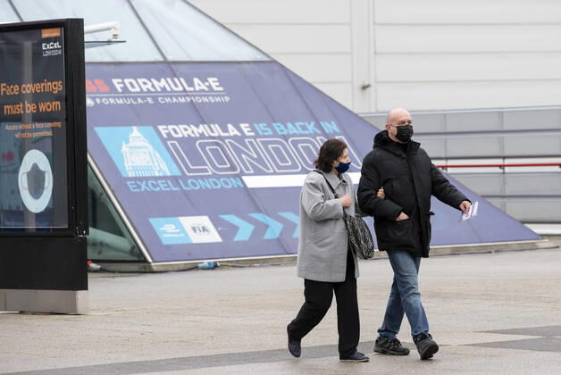(210113) -- LONDON, Jan. 13, 2021 -- People wearing face masks walk out of the Vaccination Centre at ExCel exhibition centre after receiving the vaccination in London, Britain, Jan. 12, 2021. British Prime Minister Boris Johnson on Monday warned against false complacency as the country is seeking to speed up the coronavirus vaccine rollout. According to the prime minister, 2.4 million coronavirus jabs have been administered across Britain. Seven new mass vaccination sites in England opened Monday, as the country races against time to bring the pandemic under control. ) BRITAIN-LONDON-COVID-19-VACCINE ROLLOUT HanxYan 