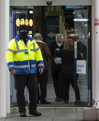 (210113) -- LONDON, Jan. 13, 2021 -- A security personnel is seen outside the Vaccination Centre at ExCel exhibition centre in London, Britain, Jan. 12, 2021. British Prime Minister Boris Johnson on Monday warned against false complacency as the country is seeking to speed up the coronavirus vaccine rollout. According to the prime minister, 2.4 million coronavirus jabs have been administered across Britain. Seven new mass vaccination sites in England opened Monday, as the country races against time to bring the pandemic under control. ) BRITAIN-LONDON-COVID-19-VACCINE ROLLOUT HanxYan 