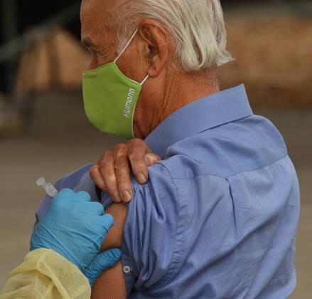 A resident is inoculated with the Moderna COVID-19 vaccine at the Balboa Sports Center vaccination site in Los Angeles on Tuesday, January 12, 2021. People aged 65 and older and those with serious.underlying health conditions in Los Angeles and across California could quickly become eligible for a COVID-19 vaccine, with federal officials urging states Tuesday to more widely distribute the shots.  LAP2021011201 JIMxRUYMEN