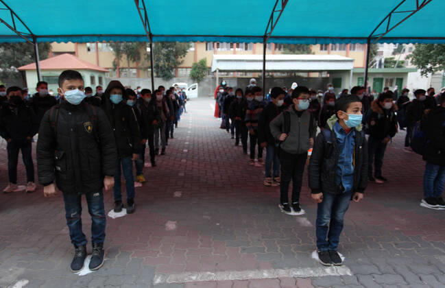 January 13, 2021, Gaza City, Gaza Strip, Palestinian Territory: Palestinian students wearing protective face masks, participate in a morning activity as schools gradually reopen amid the coronavirus disease (COVID-19) outbreak, at their school in Gaza city on January 13, 2021. In a written statement, the Palestinian Health Ministry said 7 more people have died from the virus in the last 24 hours in Gaza strip and that 437 new cases have been identified Gaza City Palestinian Territory - ZUMAap3_ 20210113_zaf_ap3_001 Copyright: xMahmoudxAjjourx