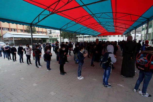 January 13, 2021, Gaza City, Gaza Strip, Palestinian Territory: Palestinian students wearing protective face masks, participate in a morning activity as schools gradually reopen amid the coronavirus disease (COVID-19) outbreak, at their school in Gaza city on January 13, 2021. In a written statement, the Palestinian Health Ministry said 7 more people have died from the virus in the last 24 hours in Gaza strip and that 437 new cases have been identified Gaza City Palestinian Territory - ZUMAap3_ 20210113_zaf_ap3_002 Copyright: xMahmoudxAjjourx