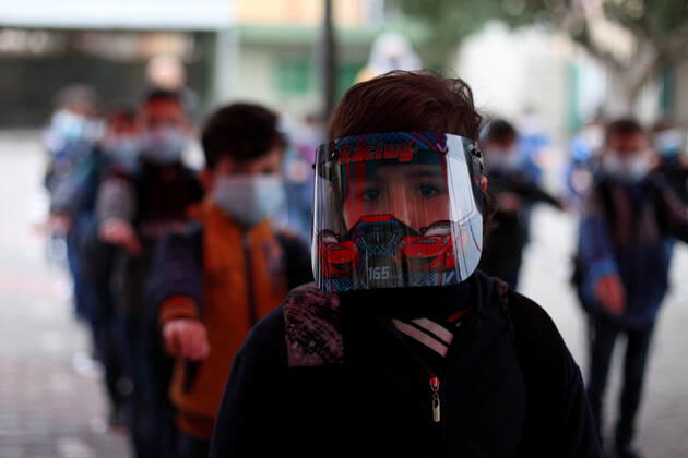 January 13, 2021, Gaza City, Gaza Strip, Palestinian Territory: Palestinian students wearing protective face masks, participate in a morning activity as schools gradually reopen amid the coronavirus disease (COVID-19) outbreak, at their school in Gaza city on January 13, 2021. In a written statement, the Palestinian Health Ministry said 7 more people have died from the virus in the last 24 hours in Gaza strip and that 437 new cases have been identified Gaza City Palestinian Territory - ZUMAap3_ 20210113_zaf_ap3_010 Copyright: xMahmoudxAjjourx