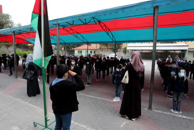 January 13, 2021, Gaza City, Gaza Strip, Palestinian Territory: Palestinian students wearing protective face masks, participate in a morning activity as schools gradually reopen amid the coronavirus disease (COVID-19) outbreak, at their school in Gaza city on January 13, 2021. In a written statement, the Palestinian Health Ministry said 7 more people have died from the virus in the last 24 hours in Gaza strip and that 437 new cases have been identified Gaza City Palestinian Territory - ZUMAap3_ 20210113_zaf_ap3_022 Copyright: xMahmoudxAjjourx