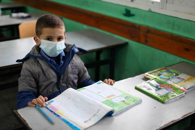 January 13, 2021, Gaza City, Gaza Strip, Palestinian Territory: Palestinian students wear protective face masks, listen to their teacher as schools gradually reopen amid the coronavirus disease (COVID-19) outbreak, at their school in Gaza city, on January 13, 2021. In a written statement, the Palestinian Health Ministry said 7 more people have died from the virus in the last 24 hours in Gaza strip and that 437 new cases have been identified Gaza City Palestinian Territory - ZUMAap3_ 20210113_zaf_ap3_025 Copyright: xMahmoudxAjjourx