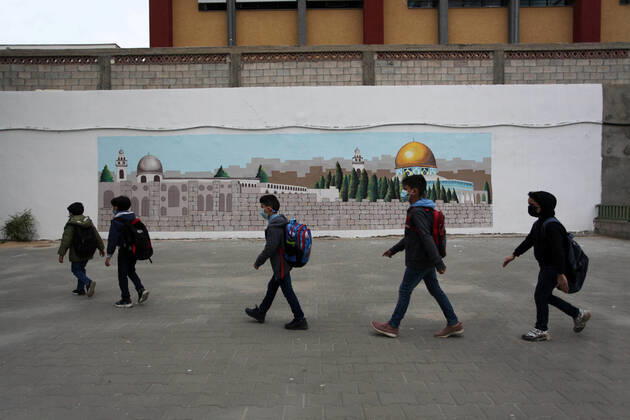 January 13, 2021, Gaza City, Gaza Strip, Palestinian Territory: Palestinian students wearing protective face masks, participate in a morning activity as schools gradually reopen amid the coronavirus disease (COVID-19) outbreak, at their school in Gaza city on January 13, 2021. In a written statement, the Palestinian Health Ministry said 7 more people have died from the virus in the last 24 hours in Gaza strip and that 437 new cases have been identified Gaza City Palestinian Territory - ZUMAap3_ 20210113_zaf_ap3_035 Copyright: xMahmoudxAjjourx