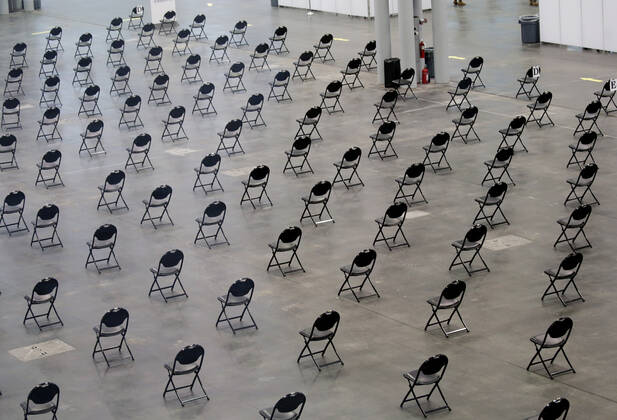 Empty chairs serve as a recovery area for patients who have just received the COVID-19 vaccination at the Jacob K. Javits Convention Center in New York City on Wednesday, January 13, 2021. The Javits Convention Center which served as a massive field hospital last spring when New York City was the epicenter of the pandemic, now will serve as a huge vaccine distribution center.  NYP20210113111 JohnxAngelillo