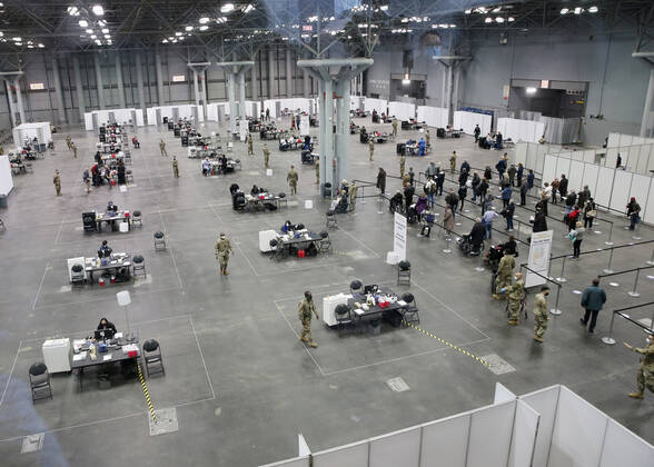 Tables and chairs are set up to deliver a COVID-19 vaccination to patients at the Jacob K. Javits Convention Center in New York City on Wednesday, January 13, 2021. The Javits Convention Center which served as a massive field hospital last spring when New York City was the epicenter of the pandemic, now will serve as a huge vaccine distribution center.  NYP20210113117 JohnxAngelillo