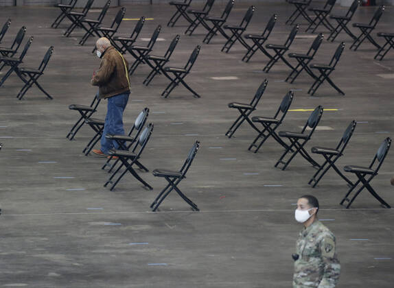 Empty chairs serve as a recovery area for patients who have just received the COVID-19 vaccination at the Jacob K. Javits Convention Center in New York City on Wednesday, January 13, 2021. The Javits Convention Center which served as a massive field hospital last spring when New York City was the epicenter of the pandemic, now will serve as a huge vaccine distribution center.  NYP20210113103 JohnxAngelillo